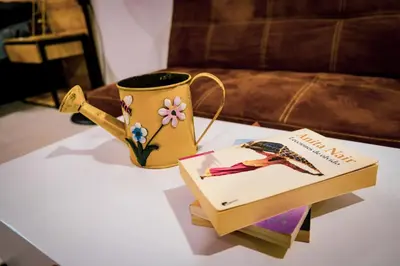 a table with a book and a cup and a coffee mug at Acogedor loft frente al tranvía in Medellín