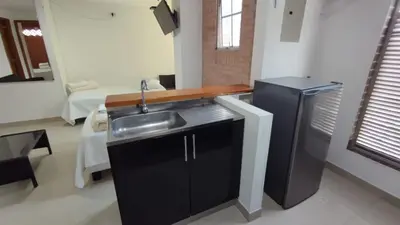 a kitchen with a sink and a refrigerator at LIVING Montes in Medellín