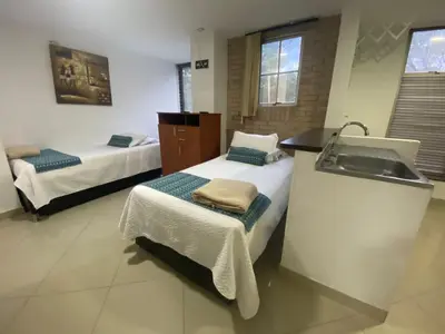 a bathroom with two beds and a sink and a sink at LIVING Montes in Medellín