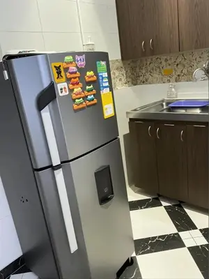 a stainless steel refrigerator in a kitchen at Aparta Suite Torre De Prado 302 in Medellín