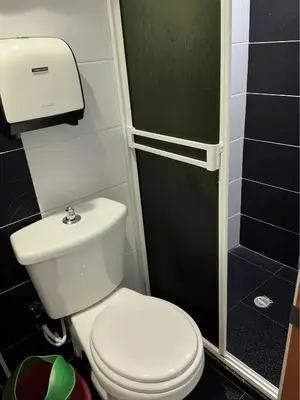 a small bathroom with a toilet and a shower at Aparta Suite Torre De Prado 302 in Medellín