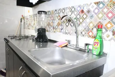 a kitchen sink with a bottle of soda on it at Aparta Suite Torre De Prado 503 in Medellín