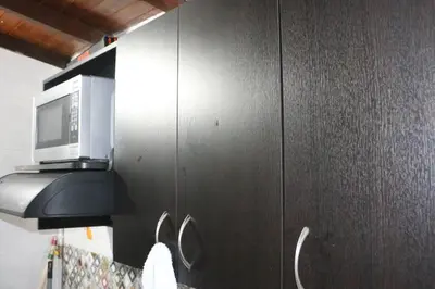 a black cabinet with a microwave on top of it at Aparta Suite Torre De Prado 503 in Medellín