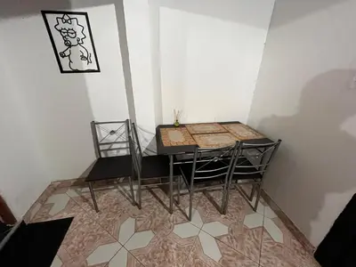a table and chairs in a corner of a room at Aparta Suite Torre De Prado 503 in Medellín