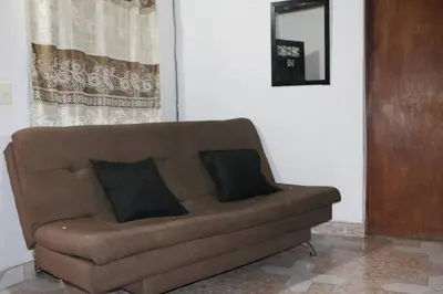 a couch in a living room with two pillows on it at Aparta Suite Torre De Prado 503 in Medellín
