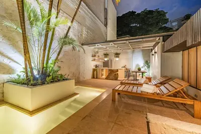 a living room with benches and plants in a building at Provenza 6 Bedroom House by HOUSY HOST in Medellín