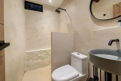 a bathroom with a toilet and a sink at Provenza 6 Bedroom House by HOUSY HOST in Medellín