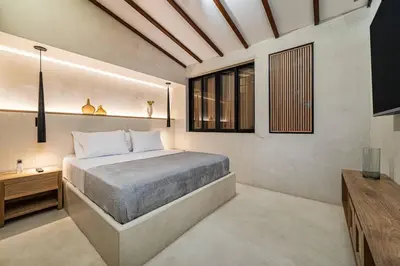 a bedroom with a large bed and a television at Provenza 6 Bedroom House by HOUSY HOST in Medellín