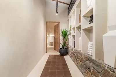 a hallway of a house with a potted plant at Provenza 6 Bedroom House by HOUSY HOST in Medellín