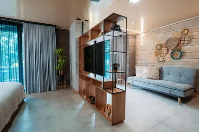 a living room with a blue couch and a television at Hotel Living by Armoniko in Medellín
