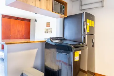 a kitchen with a refrigerator and a counter at Flat Apartamento Great Location Poblado in Medellín