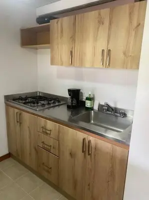 a kitchen with a sink and a stove at Flat Apartamento Great Location Poblado in Medellín