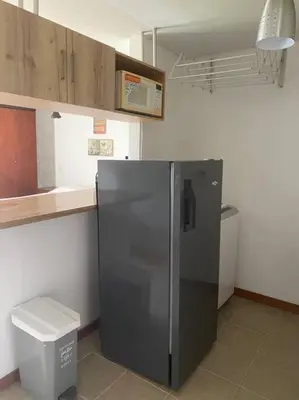 a kitchen with a black refrigerator and a toilet at Flat Apartamento Great Location Poblado in Medellín