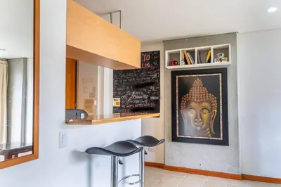 a room with a painting of a head on the wall at Flat Apartamento Great Location Poblado in Medellín