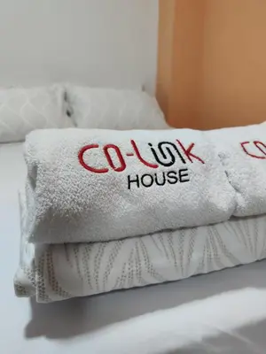 a pile of towels with the words colwx house on them at CoLinkHouse Hotel in Medellín