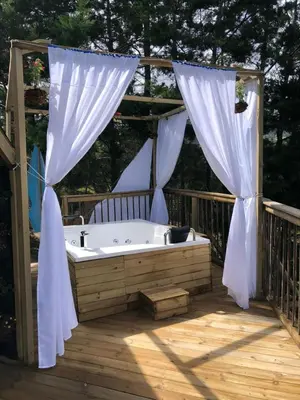 a bath tub on a deck with a gazebo at Unique Glamping / Domo Betsaida in Guatapé