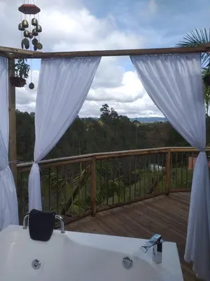 a view of a deck with a bath tub on a balcony at Unique Glamping / Domo Betsaida in Guatapé