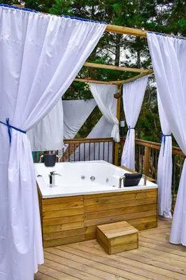 a bath tub sitting on top of a wooden deck at Unique Glamping / Domo Betsaida in Guatapé