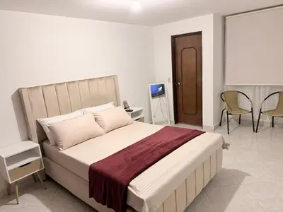 a bedroom with a bed and a table and chairs at Alojamiento Laureles la 33 in Medellín