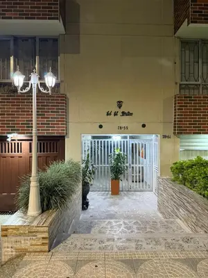 a building with a gate and a light pole at Alojamiento Laureles la 33 in Medellín
