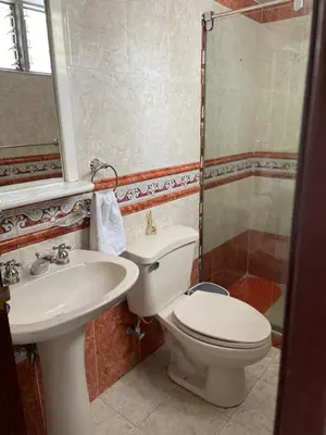a bathroom with a toilet and a sink and a shower at Alojamiento Laureles la 33 in Medellín