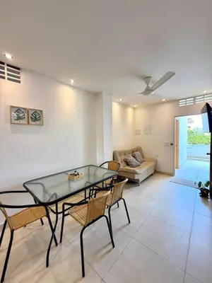 a living room with a glass table and chairs at Apartamento de Descanso - Doradal in Doradal