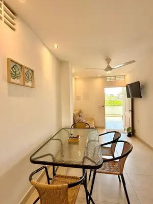 a dining room with a glass table and chairs at Apartamento de Descanso - Doradal in Doradal