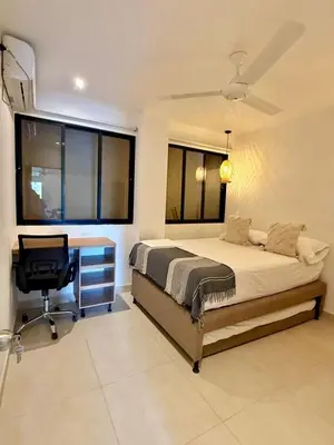 a bedroom with a bed and a desk and a chair at Apartamento de Descanso - Doradal in Doradal