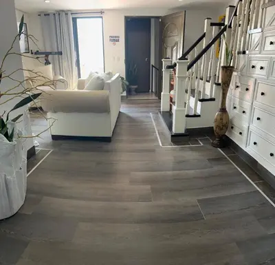 a living room with wood floors and a staircase at El Balcón De Las Montañas in Medellín