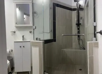 a bathroom with a shower and a sink and a mirror at El Balcón De Las Montañas in Medellín