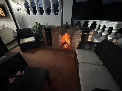 a living room with a fireplace and a couch at El Balcón De Las Montañas in Medellín