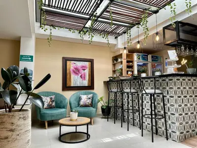 a waiting room with two chairs and a table at Laureles Guest House LGH Hotel in Medellín
