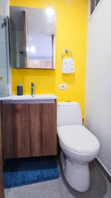 a bathroom with a white toilet and a sink at Ulivin Coliving in Manizales