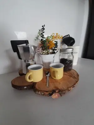 a tray with two coffee cups and flowers on a table at Casa García Rent Home in Guatapé