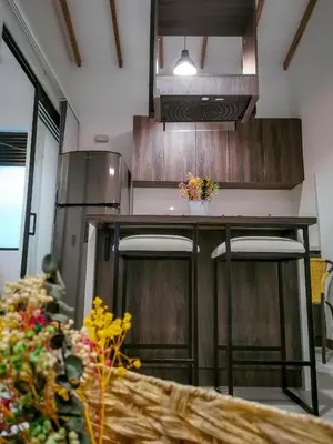 a kitchen with a counter with stools in it at Casa García Rent Home in Guatapé