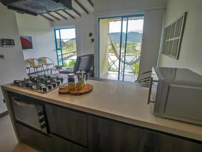 a kitchen with a stove and a counter top at Casa García Rent Home in Guatapé