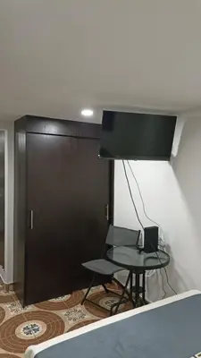 a room with a table and a black door at Hermoso apto con excelente vista in Bello