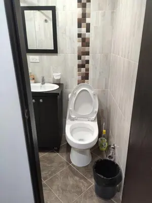 a bathroom with a toilet and a sink at Hermoso apto con excelente vista in Bello