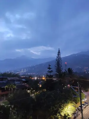 a view of a city at night at Hermoso apto con excelente vista in Bello