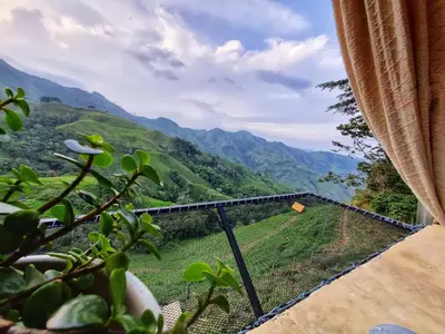 a window with a view of a mountain at Casa Mostaza-Ecolodge in Samaná