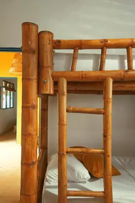 a wooden bunk bed in a room with a ladder at Casa Mostaza-Ecolodge in Samaná