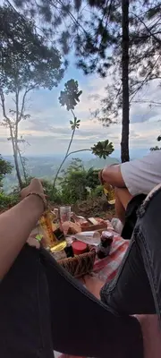 a person sitting on top of a picnic table at Casa Mostaza-Ecolodge in Samaná