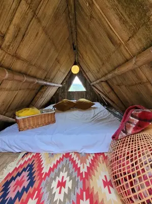 a bed in a tent with a roof at Casa Mostaza-Ecolodge in Samaná