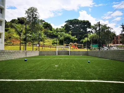 a soccer field with two balls on the grass at Acogedor, Gran Vista a las Montañas y a la Ciudad! in Santa Fe de Antioquia