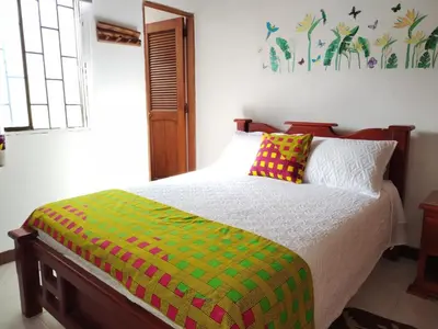 a bedroom with a bed with a colorful blanket at Etnias Hotel tematico in Quibdó