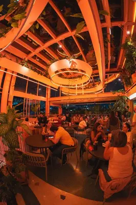 a group of people sitting at tables in a restaurant at The Somos Bold Hotel in Medellín