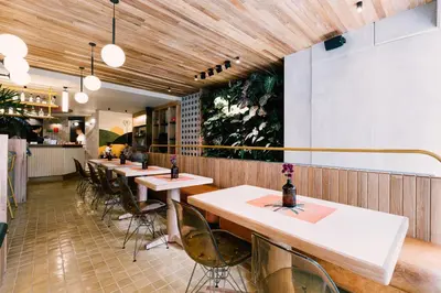 a row of tables and chairs in a restaurant at The Somos Bold Hotel in Medellín