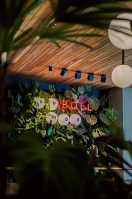 a bunch of clocks hanging from a ceiling at The Somos Bold Hotel in Medellín