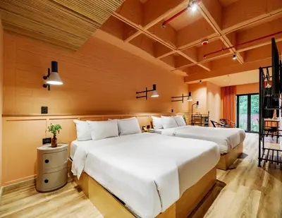 two beds in a room with wooden walls at The Somos Bold Hotel in Medellín