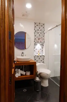 a bathroom with a sink and a toilet and a mirror at Hotel Entre Brumas in Aguadas